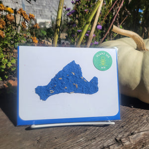 A blue cut out design of Martha's Vineyard on a white card background.