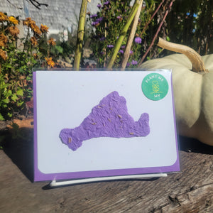A purple cut out design of Martha's Vineyard on a white card background.