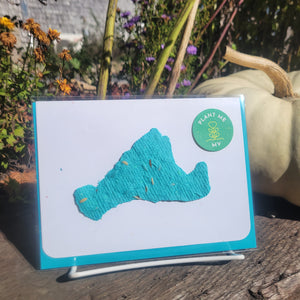 A turquoise cut out design of Martha's Vineyard on a white card background.