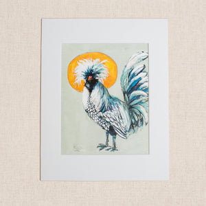 A matted print of pale blue bird with a yellow moon behind it