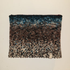A cowl with colors ranging from white to dark brown to dark blue