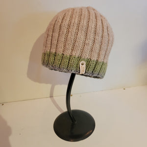 This medium sized hat has a tan brown top followed by a trim of green edge
