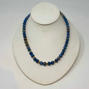 A necklace with ocean colored beads and gold filled beads