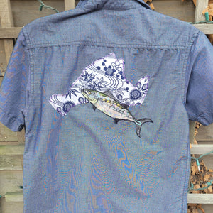 A blue button up with a blue lined island and a silver fish