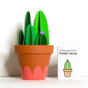 A large paper cut cacti  with an orange pattern on the pot