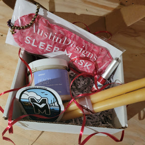 Gift box with an herbal sleep mask, body butter, lip gloss, and other gift items.