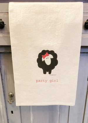 A towel with a black sheep with a pink bow on top of her head. Underneath her is the words "Party Girl"