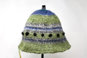 This is a blue and green hat with black dots