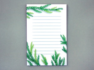 A note pad with vines on the tops and bottom of it