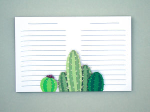 A horizontal notepad with a cacti design in the middle of it.